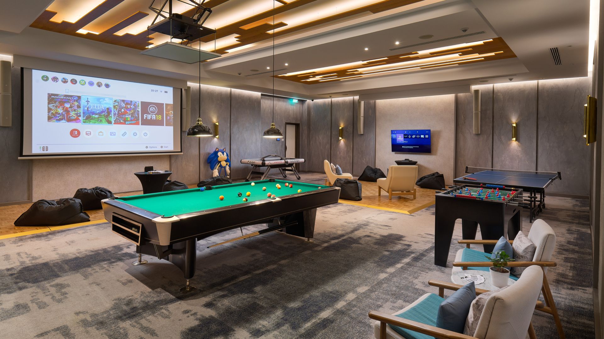 Photo Inside The Playroom Showing A Billiard Table, Chairs And A Big Screen At Chedi Lustica Bay 