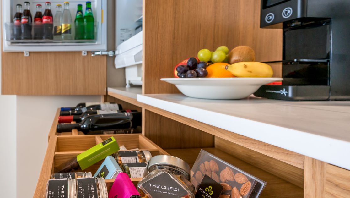 Grand Deluxe Suite Minibar And Coffee Capsules, Coffee Machine, Fruits And Soda Bottles. 
