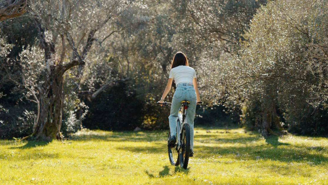 A Person Riding A Bike In A Field Of Yellow Flowers