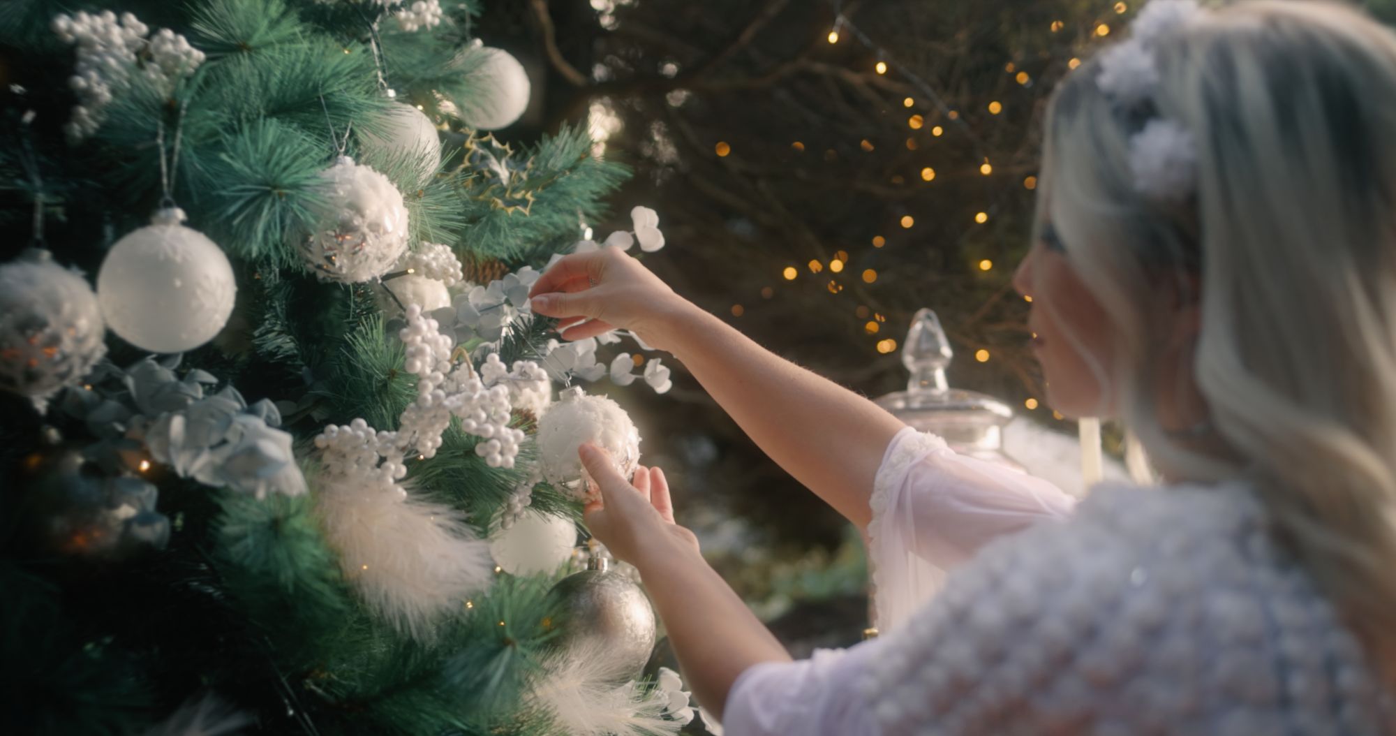 A Girl Holding A Christmas Tree